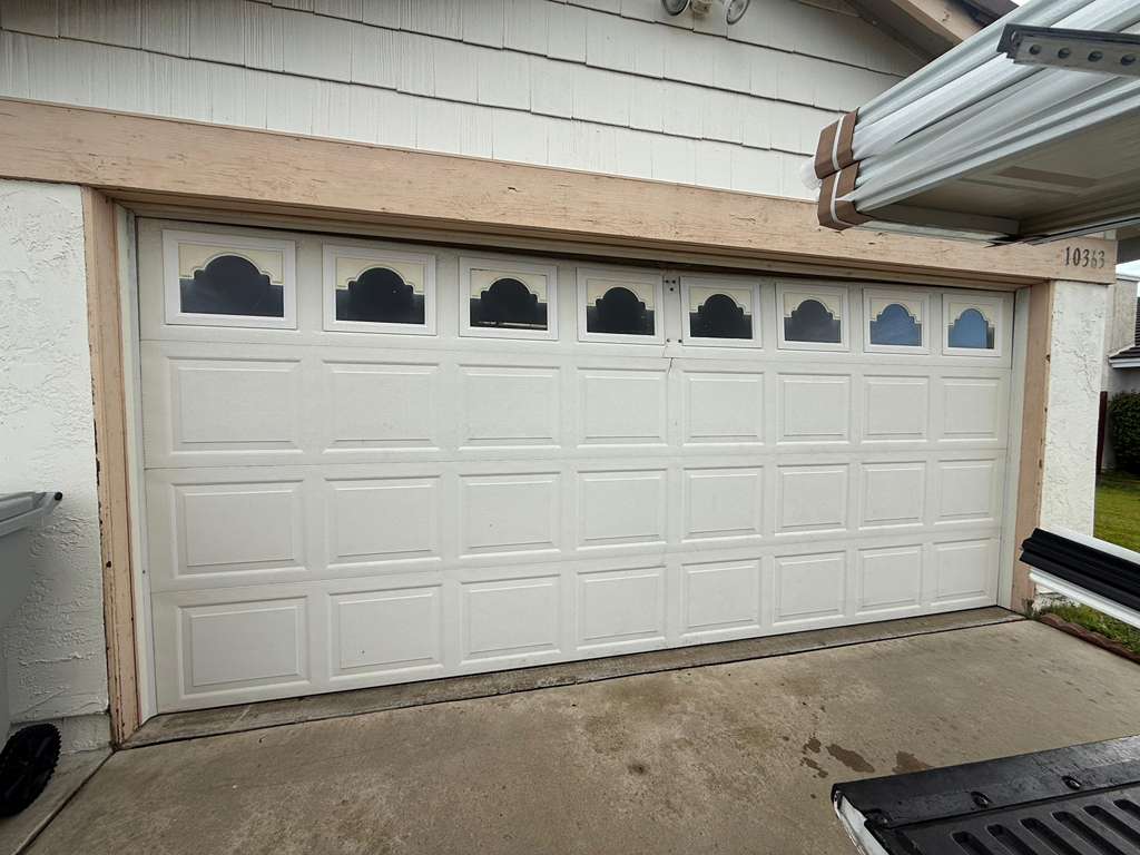 White raised panel garage door with cathedral windows
